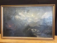 Framed oil on canvas painting showing overall moonlit landscape