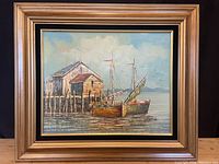 Full view of the framed acrylic painting showing two docked sailboats and wooden dock buildings against a calm sky and water background.