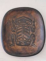 Top view of the rectangular clay bowl showing the Haida Frog design engraved inside with brown and black tones.