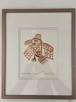Full view of framed bronzed print of Haida Raven Xuuya showing artwork and frame.