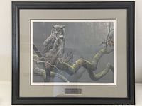 Full frontal view of framed print showing black wooden frame and grey double mat