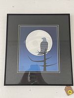 Full view of framed print showing the artwork with eagle in front of moon in blue tones, under glass frame.
