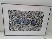 Framed pen drawing with overlapping circles containing fish and detailed leaf-filled background.