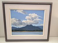 Full framed oil painting depicting mountain landscape with cloudy sky.