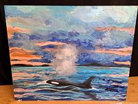 Frontal image showing the full oil painting of an orca whale at sunset in water with a colorful cloudy sky, signed by Brasset.