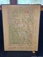 Full view of a framed vintage map of Brentwood Bay in BC, Canada, showing colors and topography details.