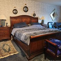 Full view of king size sleigh bed frame with two nightstands, bedding shown for scale