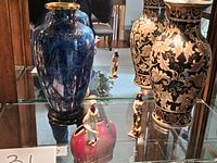 Full display of two large Chinese vases and two figurines on glass shelf showing size and detail