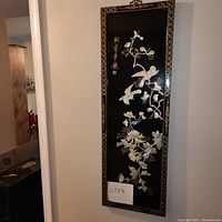 Full view of the framed oriental bird and flower art made of mother of pearl on black lacquer background.