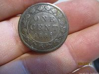 Reverse side showing denomination 'ONE CENT 1884' surrounded by decorative wreath