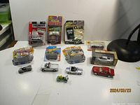 Photo shows all cars laid out on a white surface including three blister pack cars and multiple loose cars