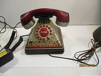 Full view of the Coca-Cola rotary dial telephone showing the handset, base, rotary dial and cords
