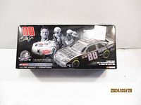 Box front showing Dale Jr. photo and 1:24 scale die cast car depiction with price sticker