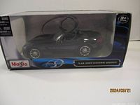 Side view of Maisto 2003 Dodge Viper die cast model car in original box.