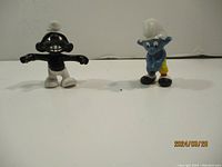 Image showing two Smurf figurines on a white surface