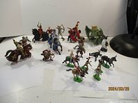 Full view of all knight and dragon figurines arranged on white background showing various poses and mounts.