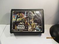 Closed Star Wars collector case with colorful 1977 Star Wars graphic of characters and space battle on lid