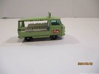 Left side profile of vintage Lesney Bottle Float truck showing milk bottles and cow logo decal