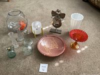 All items in the lot displayed including vintage Martinelli's bottle, angel tea light holder, white vase, and various glass pieces.