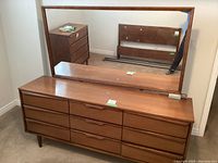 Front view of dresser with mirror attached showing six drawers and tapered legs