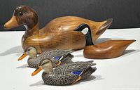 Photo showing all four hand carved wood duck decoys together with size comparison and color details.
