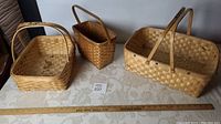 All three Mi'Kmaq baskets displayed with a ruler showing their relative sizes and scale.