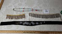 Full lot of Native Art beaded jewelry including necklace, belt and two silver beadwork strands.