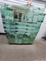 Wrapped pallet showing boxed dinnerware and glassware sets stacked on wooden pallet