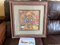 Framed 'The Spirit Takes Flight' print with visible wood frame, matting, and multicolored detailed butterfly artwork.