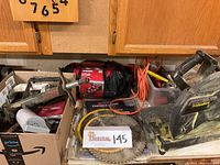 Overview photo showing the chop saw, saw blades, Husky tool bags, and assorted hand tools in boxes on a countertop