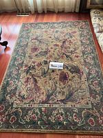 Full view of the Dalyn Century Gold area rug showing the overall floral and leaf pattern and color scheme.