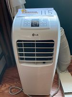 Front full view of white LG portable air conditioner with vent louvers and control panel.