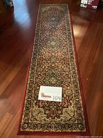 Full length of Silk Road Runner rug showing overall pattern, color, and size on wood floor.