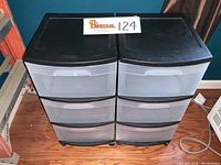 Photo of two Sterlite three-drawer rolling storage units side by side on wood floor.