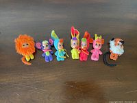 Front view of all 7 Animal Kiddles dolls in original animal costumes, showing colorful plush fabric and detailed faces.