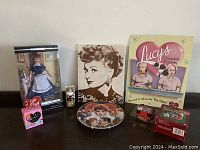 Full view of the lot showing all items including doll, photos, plates, music boxes, and figurines.