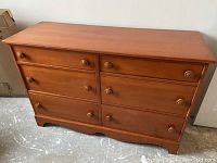 Front view of the Vilas 6 drawer dresser showing drawer layout, knobs, and overall condition.