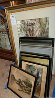 Full view of stacked 12 framed art pieces, showing different frame styles and sizes