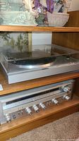 Shelf view showing Hitachi turntable on top shelf and Pioneer receiver below