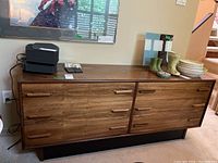 Front view of six-drawer walnut veneer dresser with wooden handles