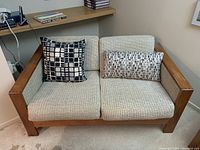 Front angle view showing overall shape, cushions, and pillows.