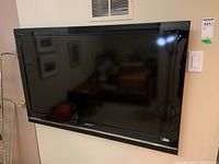 Front view of Sony Bravia TV mounted on the wall.