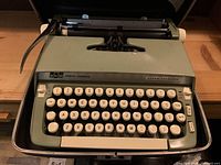 Front view of the Smith-Corona Super Sterling typewriter showing keys, carriage return lever, and metal frame.