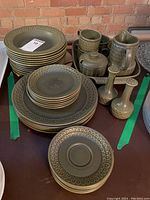 Full set of stacked Wedgwood dishes with various plates, mugs, pitcher, sugar bowl, and salt and pepper shakers on tray
