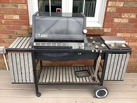 Full front view of the Weber Platinum series propane BBQ grill with side racks and burner