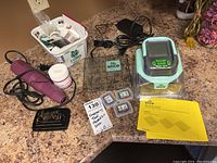 Bird's eye view of Slice Craft Machine, Hot Boss embossing tool, cartridges, manuals, glass cutting plate, power cords, embossing powder, and accessories on countertop.