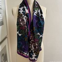 Silk scarf displayed on a mannequin showing full length and floral pattern.