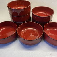 Full set of 8 glossy cherry red Villeroy and Boch Granada porcelain bowls with black rim, stacked and displayed grouped