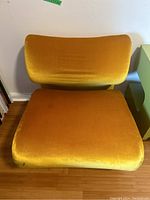 Front view of sculpted gold velour upholstered chair