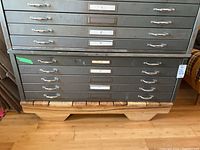 Front view showing all five drawers, chrome handles, label holders and overall finish.